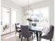Sunlit dining room with stylish seating and elegant chandelier at 167 Edgefield St, Pittsboro, NC 27312