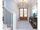 Elegant entryway features a decorative light fixture, wooden front door and stylish area rug at 167 Edgefield St, Pittsboro, NC 27312