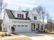 Beautiful two-story home with a white exterior, covered front porch, and attached garage at 167 Edgefield St, Pittsboro, NC 27312