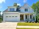 Beautiful two story home features a white exterior, attached garage and covered porch at 167 Edgefield St, Pittsboro, NC 27312