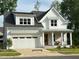 Charming two-story home with white siding, a covered front porch, and a two car garage at 167 Edgefield St, Pittsboro, NC 27312