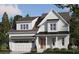 Beautiful two-story home with a white exterior, covered front porch, and attached garage at 167 Edgefield St, Pittsboro, NC 27312