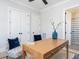Bright home office with a desk, decorative vase, and access to a tiled bathroom at 167 Edgefield St, Pittsboro, NC 27312