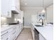 Bright kitchen with white cabinets, quartz countertops, and stainless steel appliances at 167 Edgefield St, Pittsboro, NC 27312