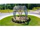 A modern metal sculpture adorns the roundabout in this beautifully landscaped community at 167 Edgefield St, Pittsboro, NC 27312