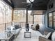 Relaxing covered deck featuring outdoor furniture, a ceiling fan, and picturesque views of the surrounding wooded landscape at 75 Ridgeline Ct, Pittsboro, NC 27312