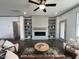 Modern living room featuring a fireplace and built-in shelving at 345 Maidenhair Pl, Clayton, NC 27520