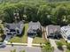 An aerial view of luxurious homes with pristine lawns, tree-lined streets, and beautifully landscaped surroundings at 5307 Dixon Dr, Raleigh, NC 27609