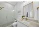 Modern bathroom with glass-enclosed shower, marble countertop, and gold fixtures at 5307 Dixon Dr, Raleigh, NC 27609