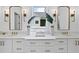 Bathroom with double sink vanity, gold fixtures, and a decorative window at 5307 Dixon Dr, Raleigh, NC 27609
