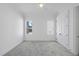 Bright bedroom featuring neutral carpet, a ceiling fan and natural light through two windows at 5307 Dixon Dr, Raleigh, NC 27609