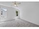 Bright bedroom featuring neutral carpet, a ceiling fan and natural light through two windows at 5307 Dixon Dr, Raleigh, NC 27609