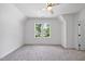A light and airy bedroom with neutral walls and carpet, featuring a ceiling fan and bright windows at 5307 Dixon Dr, Raleigh, NC 27609