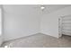 Bright bedroom featuring neutral carpet, a ceiling fan, natural light and a walk-in closet at 5307 Dixon Dr, Raleigh, NC 27609