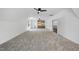 Large bonus room with neutral carpet, bar area, modern ceiling fan, and lots of natural light at 5307 Dixon Dr, Raleigh, NC 27609