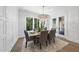 Elegant dining room with wainscoting, modern chandelier, and a view of the outdoors at 5307 Dixon Dr, Raleigh, NC 27609
