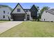 Striking home with a modern facade, dark accents, lush lawn, and a welcoming entrance at 5307 Dixon Dr, Raleigh, NC 27609