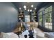 Stylish home office with custom built-ins, modern lighting, and a glass desk at 5307 Dixon Dr, Raleigh, NC 27609