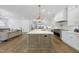 Open-concept kitchen with a large island, modern lighting, and seamless flow to living spaces at 5307 Dixon Dr, Raleigh, NC 27609