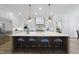 A modern kitchen featuring a spacious island with pendant lighting and ample counter space at 5307 Dixon Dr, Raleigh, NC 27609