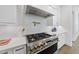 Gourmet kitchen showcasing stainless steel appliances, pot filler, and sleek white cabinetry at 5307 Dixon Dr, Raleigh, NC 27609