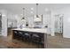 Bright, all-white gourmet kitchen featuring a large island with seating and stainless steel appliances at 5307 Dixon Dr, Raleigh, NC 27609
