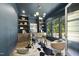 Office with a desk, decorative chandelier, wood floors, and black accent wall at 5307 Dixon Dr, Raleigh, NC 27609