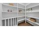 Organized pantry featuring white shelving, wood floors, and ample storage space at 5307 Dixon Dr, Raleigh, NC 27609