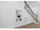 Elegant staircase featuring custom molding, iron railings, hardwood floors and built-in shelving at 5307 Dixon Dr, Raleigh, NC 27609