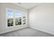 Bedroom with large window, carpeted floor, and neutral wall paint at 2009 Abbeyhill Dr # 63, Raleigh, NC 27610