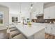 Bright kitchen boasts a large island with seating, quartz countertops, and modern appliances at 2009 Abbeyhill Dr # 63, Raleigh, NC 27610