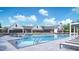 Resort-style pool with lounge chairs, clear blue water, and beautiful clubhouse in the background at 2009 Abbeyhill Dr # 63, Raleigh, NC 27610