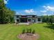 Expansive backyard features lush lawn, a modern home design, and a private, wooded setting at 213 Westhampton Dr, Pittsboro, NC 27312
