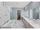 Bathroom featuring double vanity, soaking tub, marble tile, and access to a walk-in closet at 213 Westhampton Dr, Pittsboro, NC 27312