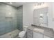 Modern bathroom with walk-in glass shower, white vanity, and decorative tile at 213 Westhampton Dr, Pittsboro, NC 27312