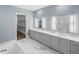 Primary bath with dual sinks, vanity, and marble floors leading to the walk in closet at 213 Westhampton Dr, Pittsboro, NC 27312