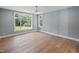 Bright bedroom with hardwood floors, ceiling fan and large window overlooking backyard at 213 Westhampton Dr, Pittsboro, NC 27312