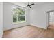 A spacious bedroom features a ceiling fan, recessed lights, and large windows overlooking the property at 213 Westhampton Dr, Pittsboro, NC 27312