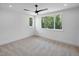 Large bedroom featuring carpet, ceiling fan, recessed lights, and expansive windows showing wooded views at 213 Westhampton Dr, Pittsboro, NC 27312