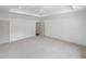 Bright bedroom with neutral carpet, trey ceiling, ceiling fan, and multiple doorways at 213 Westhampton Dr, Pittsboro, NC 27312