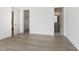 Bedroom with hardwood floors leading to an open closet and modern bathroom, offering functionality and style at 213 Westhampton Dr, Pittsboro, NC 27312