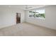 Well-lit bedroom featuring neutral carpet, ceiling fan, recessed lighting and scenic outdoor views at 213 Westhampton Dr, Pittsboro, NC 27312