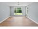 Spacious bedroom bathed in natural light from multiple windows overlooking a large yard at 213 Westhampton Dr, Pittsboro, NC 27312