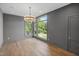 Bedroom with large windows offering scenic views and a modern chandelier at 213 Westhampton Dr, Pittsboro, NC 27312