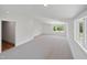 Bright bonus room features neutral carpet, recessed lighting, and large windows with natural light at 213 Westhampton Dr, Pittsboro, NC 27312