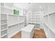 Spacious walk in closet with custom shelves, drawers and center island at 213 Westhampton Dr, Pittsboro, NC 27312