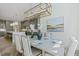 Open-concept dining area with statement lighting fixture and stylish decor adjacent to kitchen at 213 Westhampton Dr, Pittsboro, NC 27312