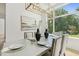Bright dining room featuring modern chandelier, large windows, and elegant table setting at 213 Westhampton Dr, Pittsboro, NC 27312