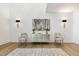 Bright entryway featuring hardwood floors, accent chairs, decorative art, and modern lighting sconces at 213 Westhampton Dr, Pittsboro, NC 27312