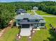 Aerial view of a modern home, highlighting its well-maintained lawn and private, wooded surroundings at 213 Westhampton Dr, Pittsboro, NC 27312